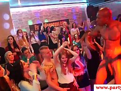 Horny woman is sucking a black man’s huge cock, while other people are watching, at the party