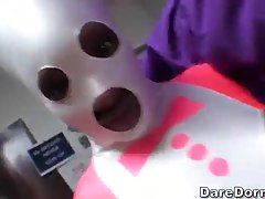 Dark haired babe in golden costume is kneeling in front of her lover and sucking his dick